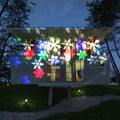 Garden Snow Lamp solar LED snowflake light with red, green, and blue multicolour glow placed in a garden lawn