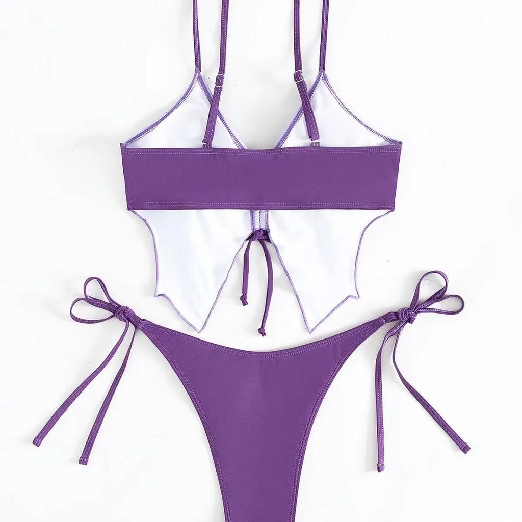 Women's purple bow ins style split bikini set with briefs, on a mannequin.