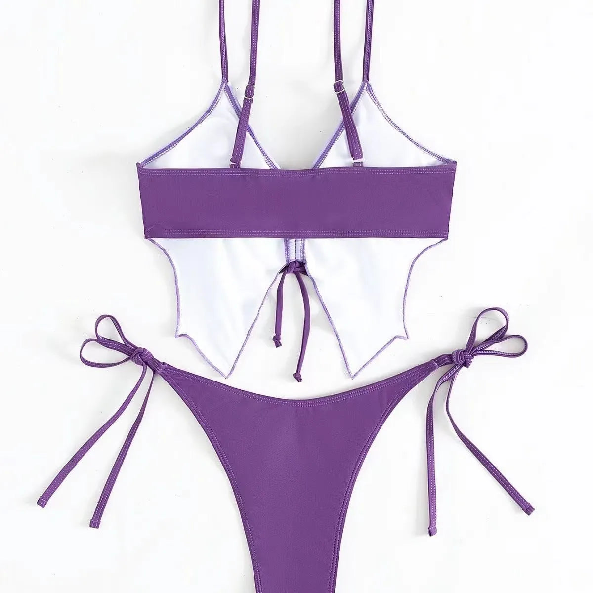 Women's purple bow ins style split bikini set with briefs, on a mannequin.
