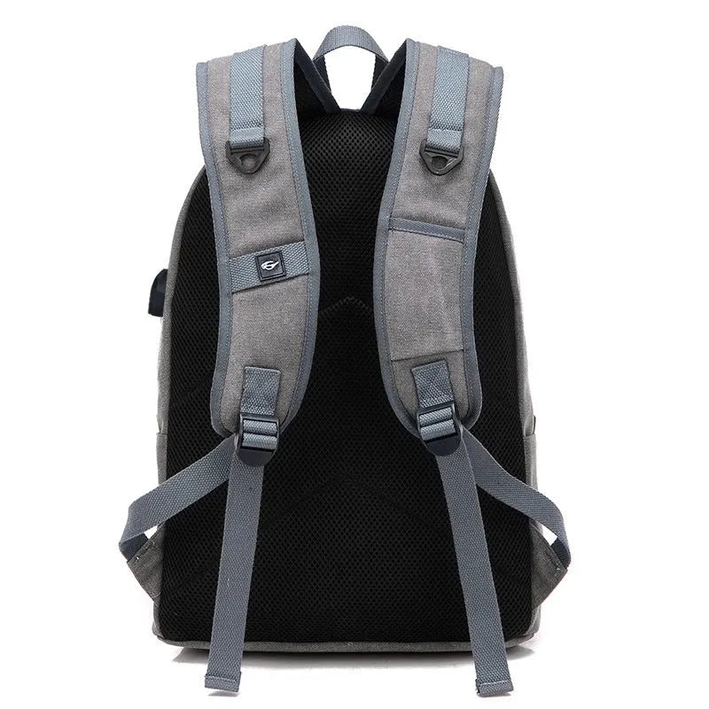Canvas USB charging backpack in grey colour showing front pockets and side USB port.