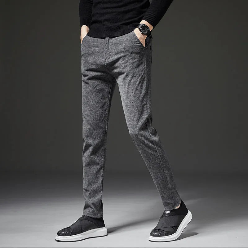 Men's slim casual trousers in polyester fibre, available in black, blue and grey, sizes 28 to 38.