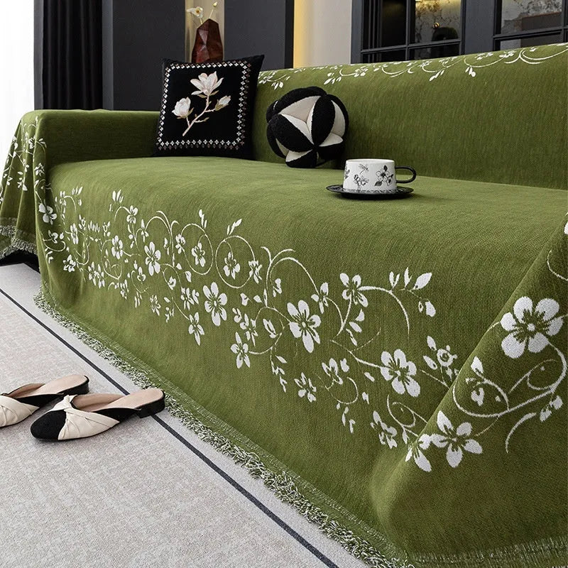 Chenille sofa cover with embroidered magnolia pattern in garland black, coffee, and green colours