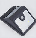 Set of four white solar-powered LED security lights with motion sensors for outdoor wall or post mounting.