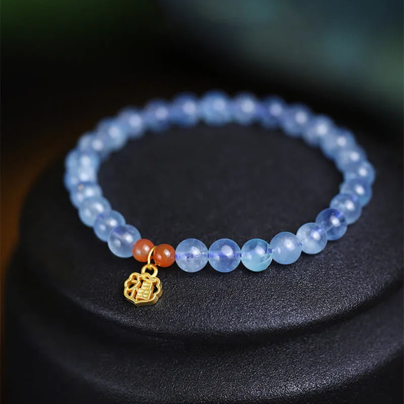 Ice translucent aquamarine bracelet with 8mm round beads and silver sequin accents