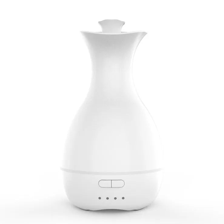 White ultrasonic aromatherapy humidifier with 200ml tank and colourful night light on wooden surface