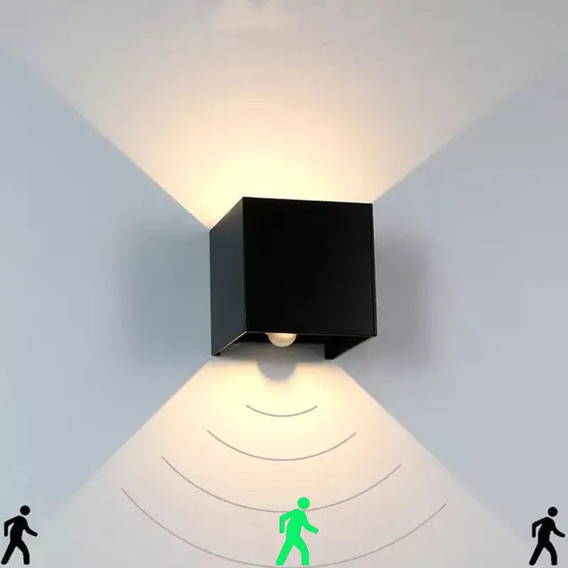 Square aluminium alloy wall lamp in black, mounted on a wall, showcasing its compact design and 360-degree light output.