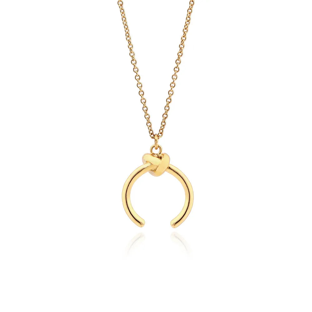 Gold and silver geometric copper pendant necklace on an adjustable cross chain.