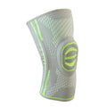 A cotton mountaineering knee pad in blue, shown on a knee.