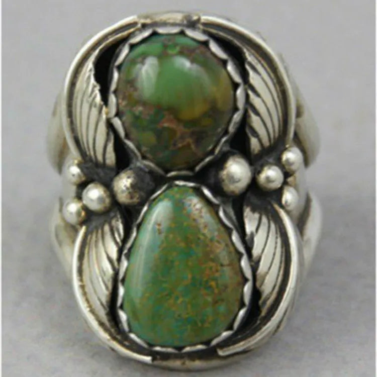 Women's retro geometric alloy ring with a turquoise inlaid design, shown on a finger.