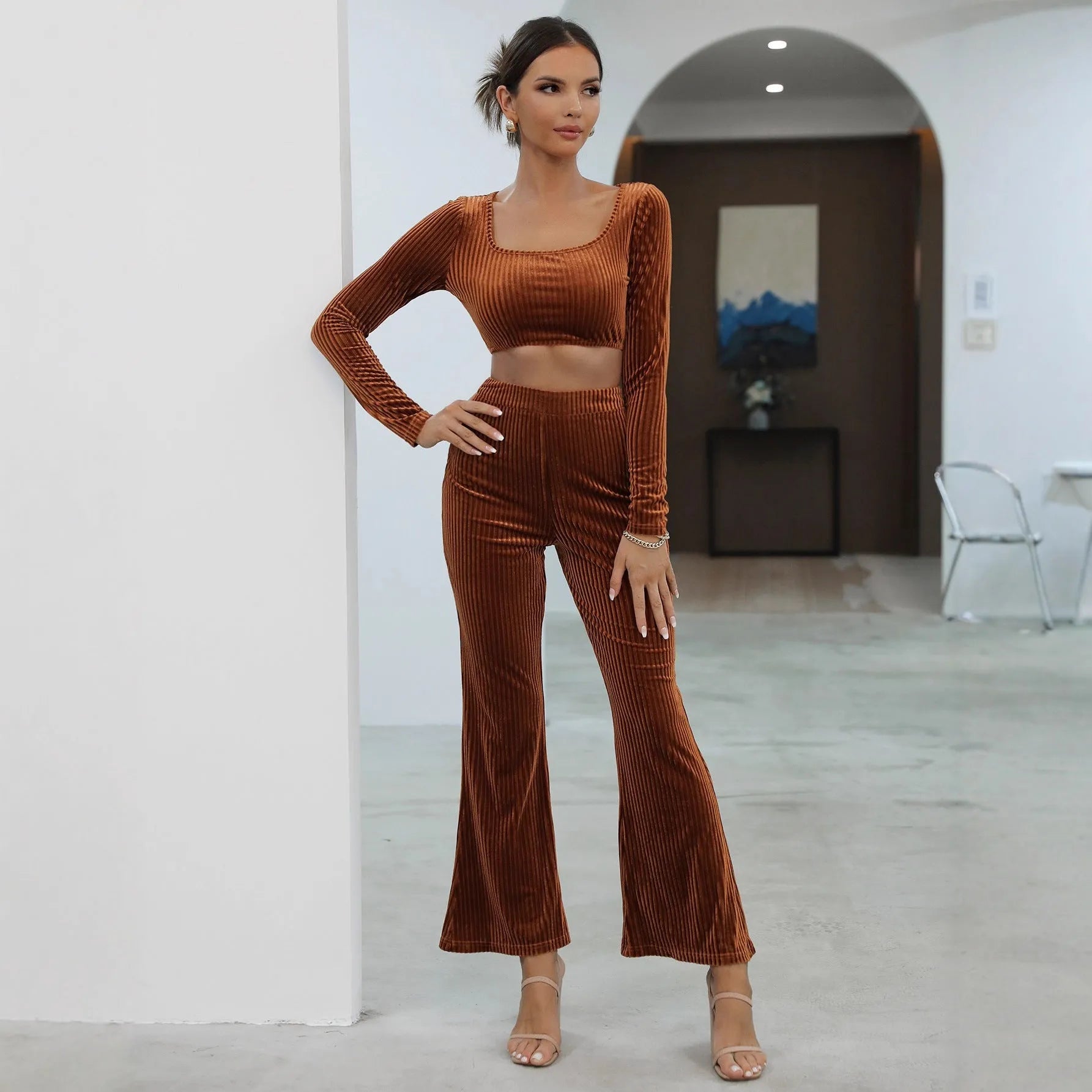 Caramel coloured women's long sleeve sweater and trouser casual set on a hanger.