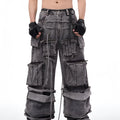 A pair of grey distressed denim overalls with rope stitching, shown on a model.