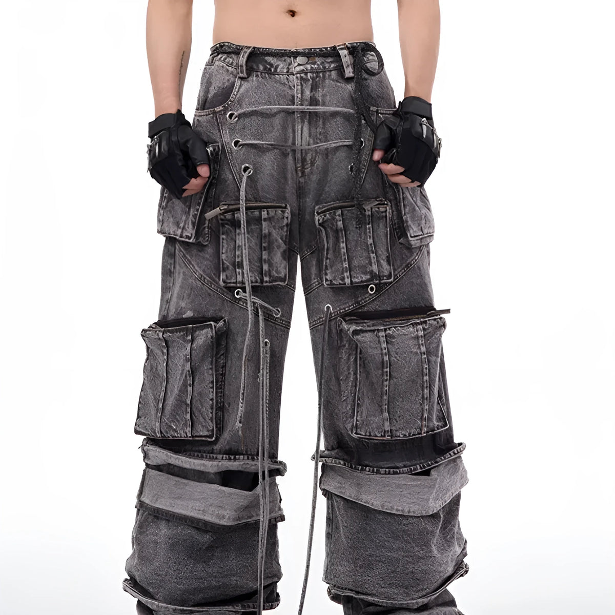 A pair of grey distressed denim overalls with rope stitching, shown on a model.