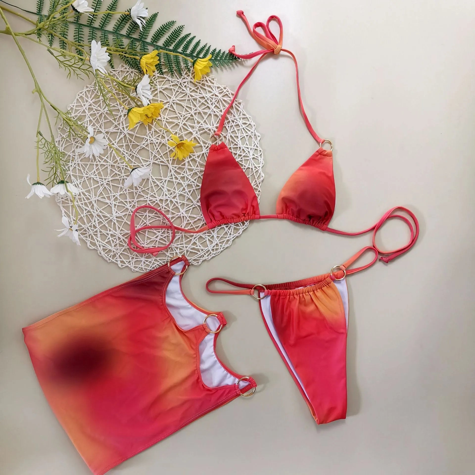 Women's tie-dye gradient three-piece bikini set with halter top and skirt on hanger