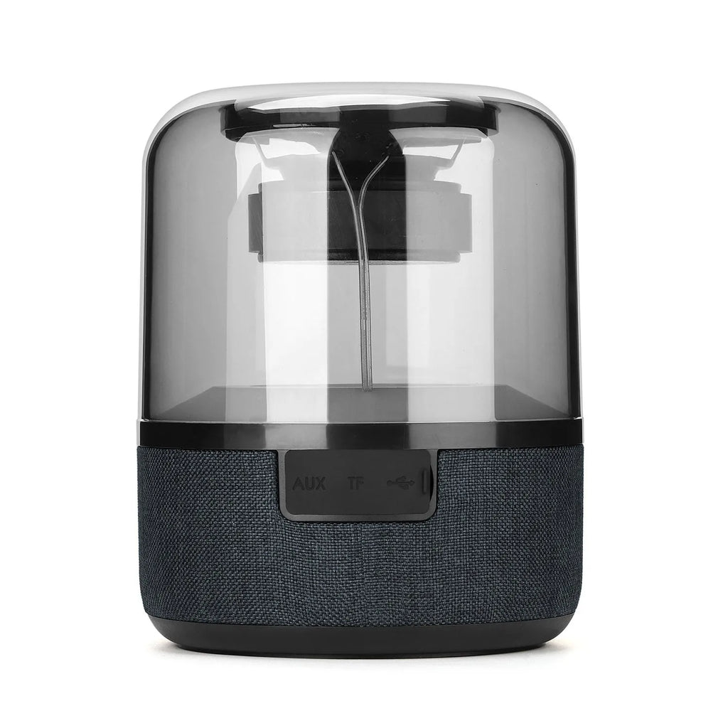 Four-colour light touch wireless Bluetooth speaker with halo lighting effect on a table.