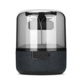 Four-colour light touch wireless Bluetooth speaker with halo lighting effect on a table.