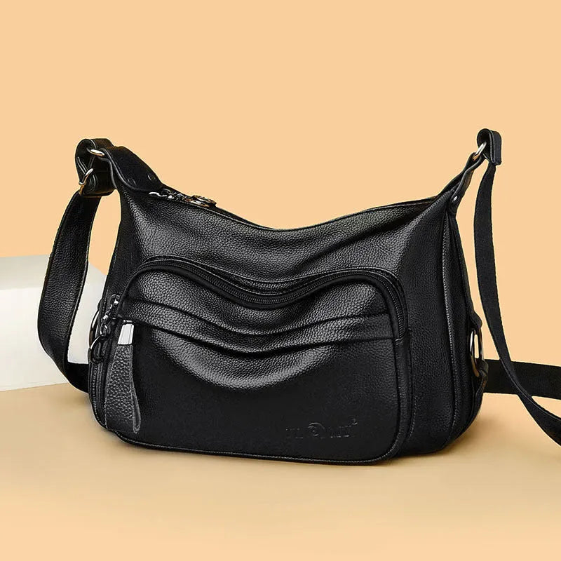 Women's blue crossbody shoulder bag with multiple interior pockets and zip closure