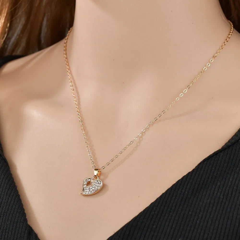 Gold tone women's love jewellery set with earrings, pendant and bracelet featuring adjustable 21-50cm sizing