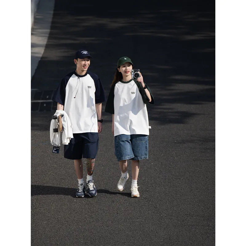 Blue casual men's t-shirt with raglan sleeves on a hanger, showing loose fit.