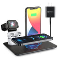 Black and white wireless charging station for mobile phone, smartwatch, and headphones on a desk.