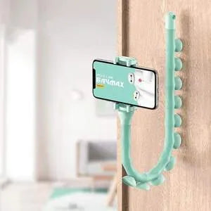 Flexible rubber phone holder with suction cup mounted on a surface showing 360-degree rotation capability