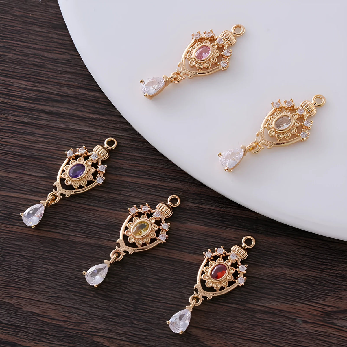 Copper water drop pendant with micro inlaid zircon crown design in gold, rose gold, or silver electroplate.