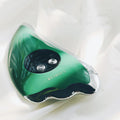 Green plastic and metal facial beauty instrument with three mode buttons and USB cable