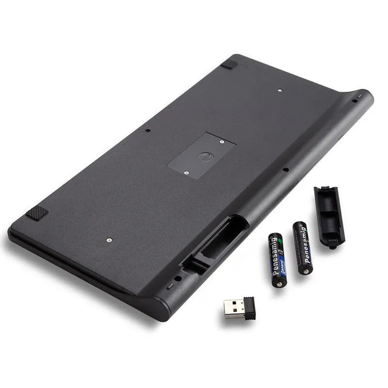 Black and white 2.4 GHz wireless keyboard and mouse set with USB receiver on a desk.