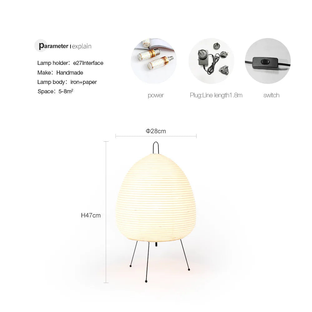 Nordic style table lamp with a handmade Japanese rice paper shade and aluminium base on a wooden table.