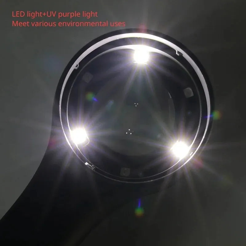 Black and silver handheld appraisal magnifying glass with optical glass lens and USB-C cable on a table.