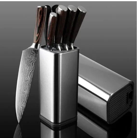 Black stainless steel kitchen tool holder with detachable base next to knives and cutlery