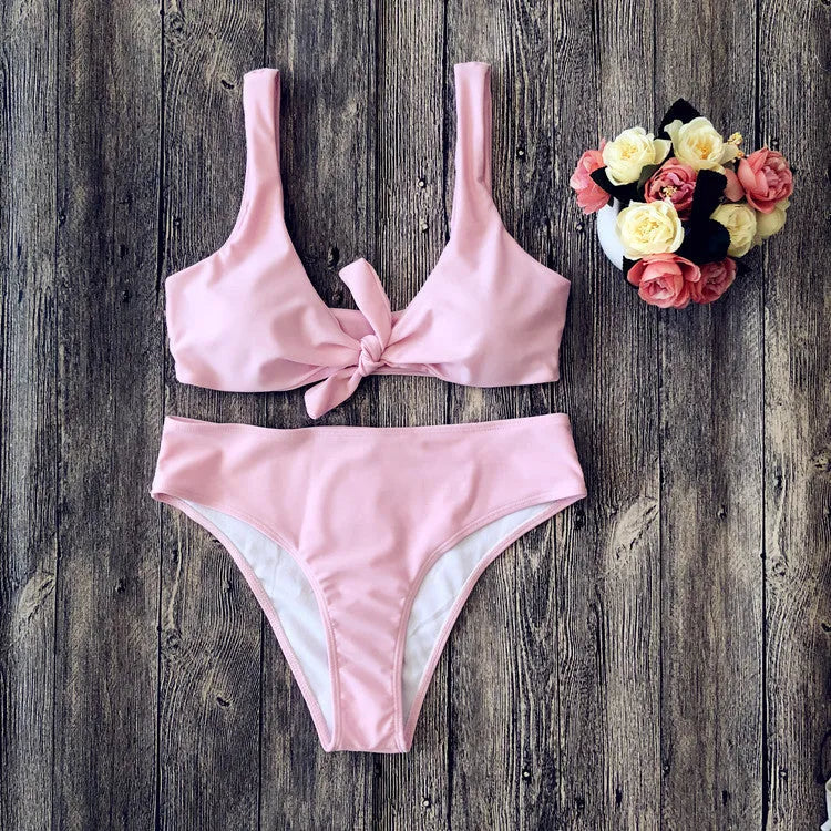 Solid colour bikini set on hanger, showing bra top and briefs in black, pink, red, white, or wine red.