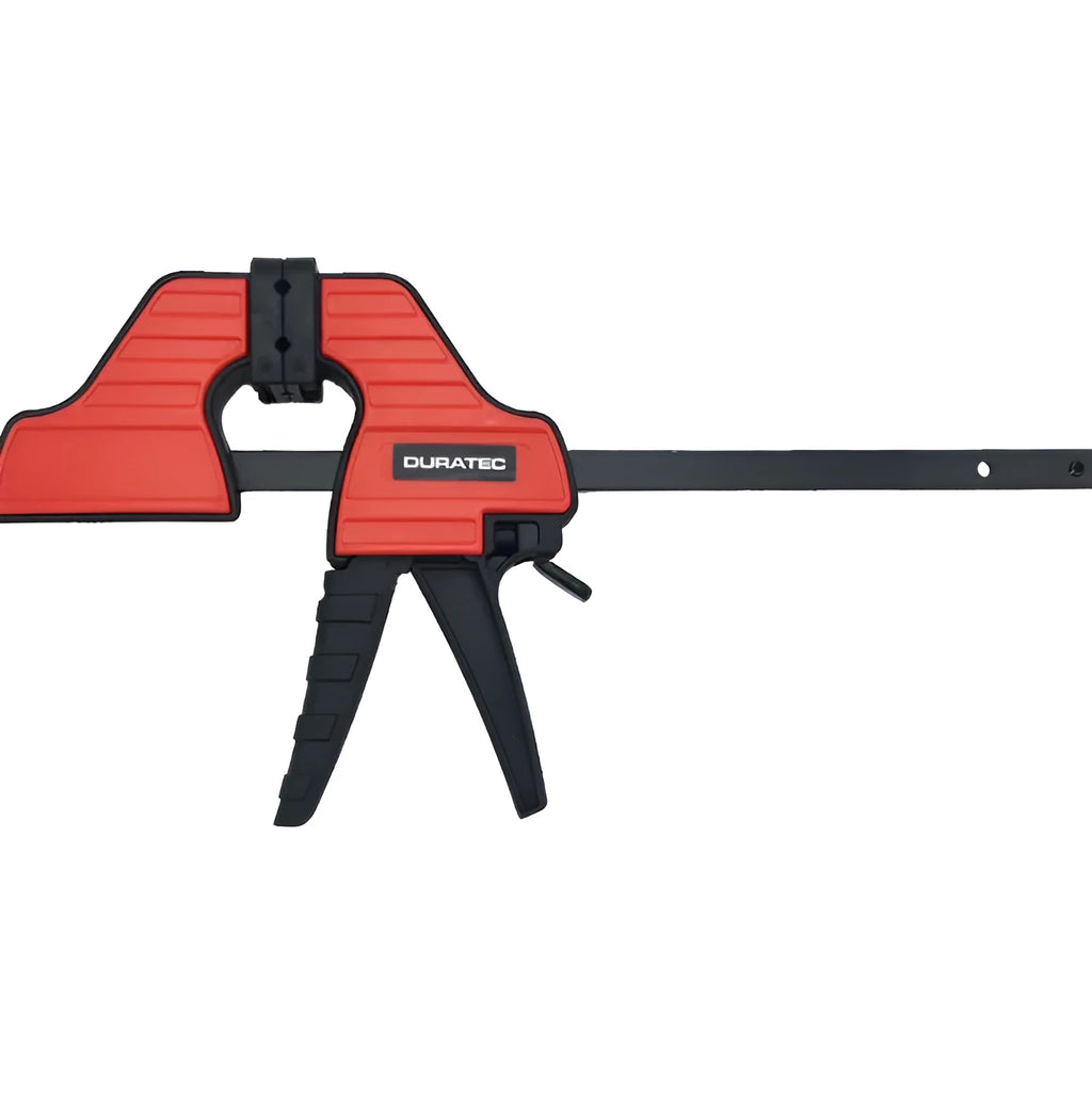 Black plastic woodworking clamp with rubber grip showing quick adjustment key and clamping mechanism