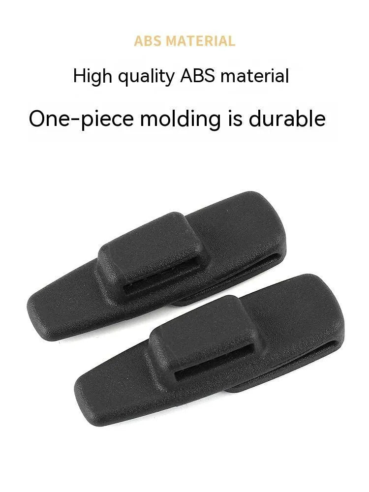 Black ABS plastic car seatbelt stopper clips preventing automatic retraction