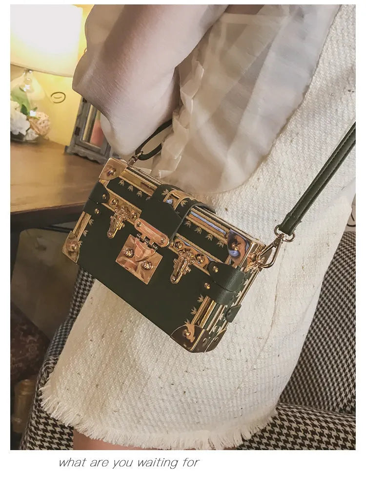Hard structured black PU leather women's shoulder bag with decorative rivets and single adjustable strap