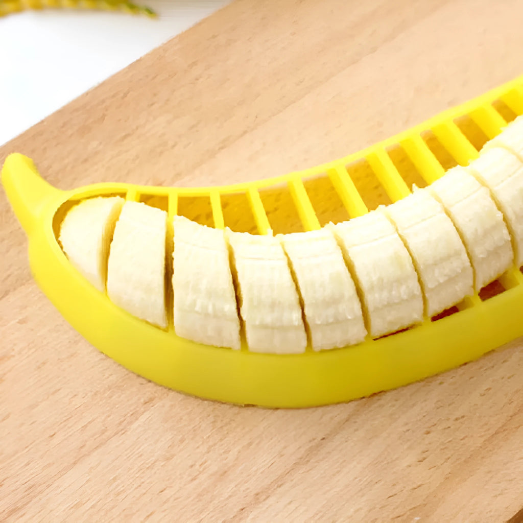 Yellow banana cutter food grade PP plastic kitchen tool approximately 25 cm long on a white background