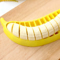 Yellow banana cutter food grade PP plastic kitchen tool approximately 25 cm long on a white background