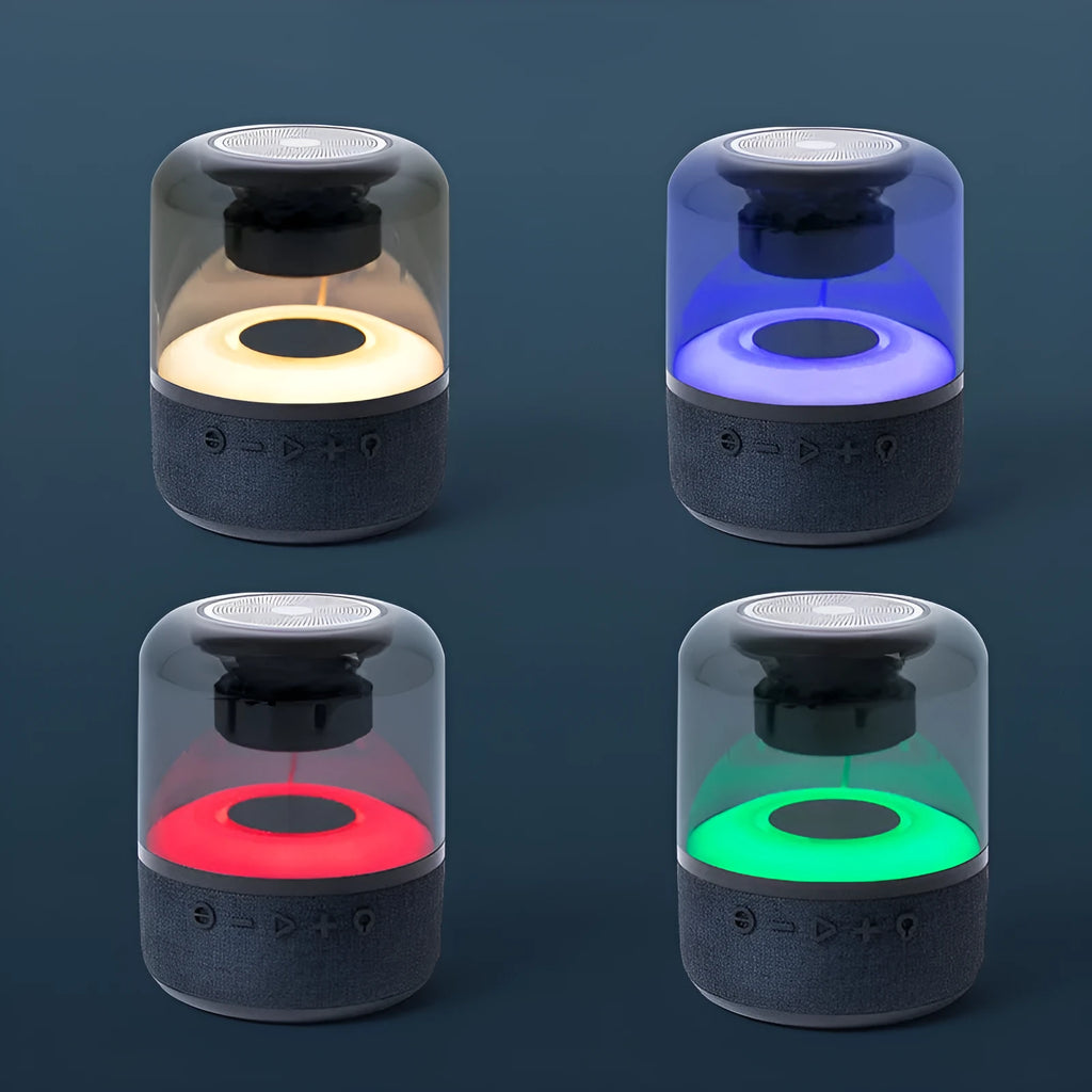 Four-colour light touch wireless Bluetooth speaker with halo lighting effect on a table.
