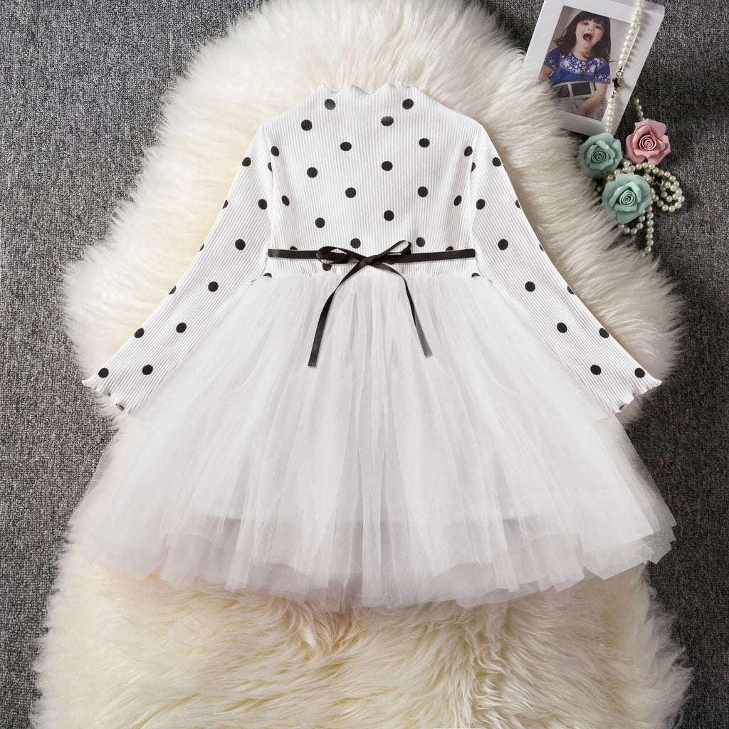 Baby girl in a long sleeve black lace tutu dress, suitable for christenings and parties.