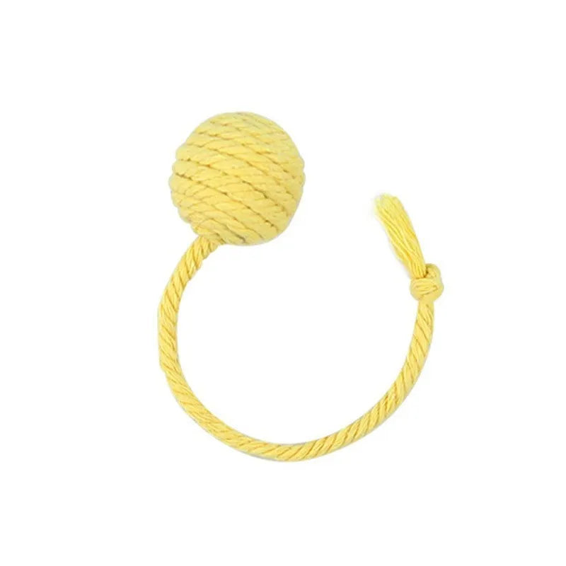 Cat toy ball with rope attached in green, pink, purple, or yellow colours with internal bell