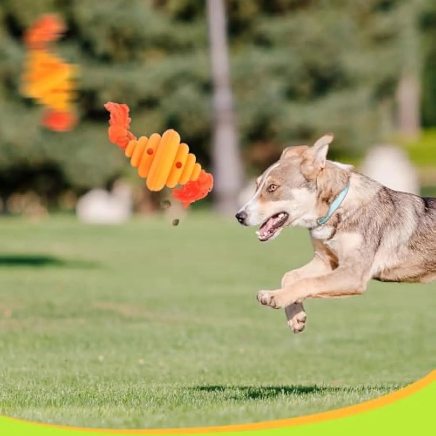 Green and yellow silicone dog ball with integrated rope, showing split spiral design for treat dispensing.