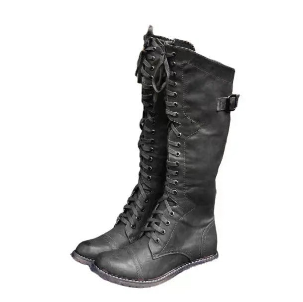 Black chunky heel high leg boot with round toe and low rubber sole
