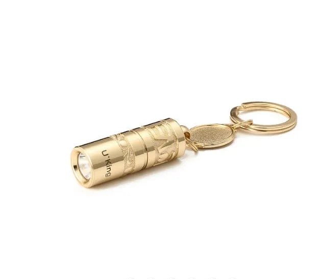 Gold zinc alloy mini LED keychain flashlight with a waterproof case and emergency light function.