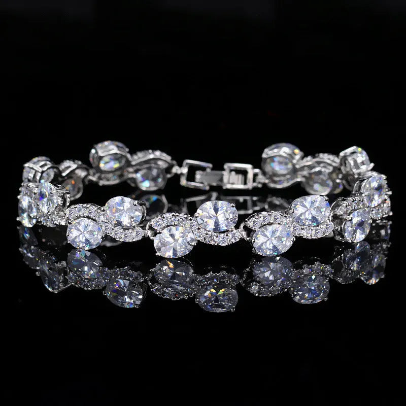 Close-up of a geometric style copper plated gold bracelet with micro inlaid white zircon stones, showing clasp detail.