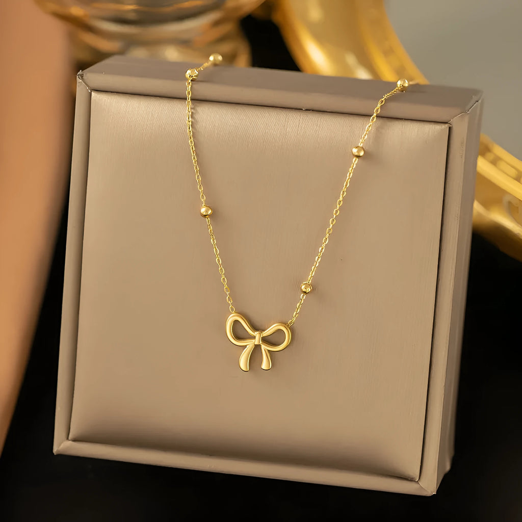 Gold electroplated bow necklace on cross chain with adjustable 41-50cm length
