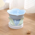 Blue ceramic raised pet bowl with floral pattern and non-slip base for cats or small dogs