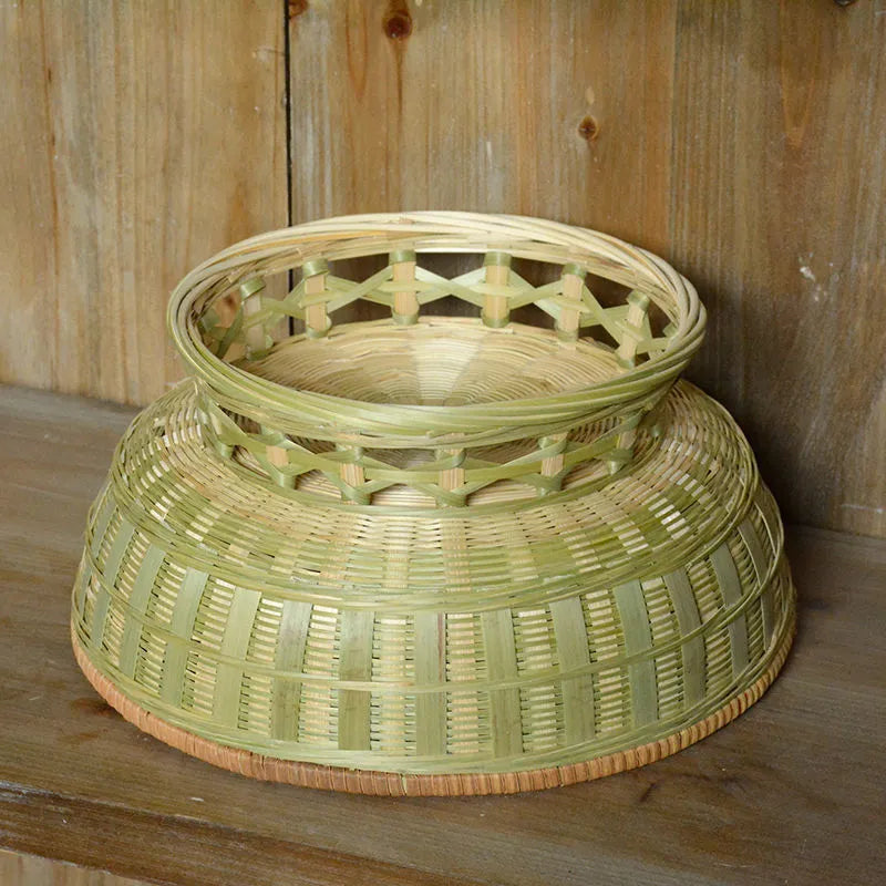 Handmade woven natural bamboo storage basket shown in a household setting.
