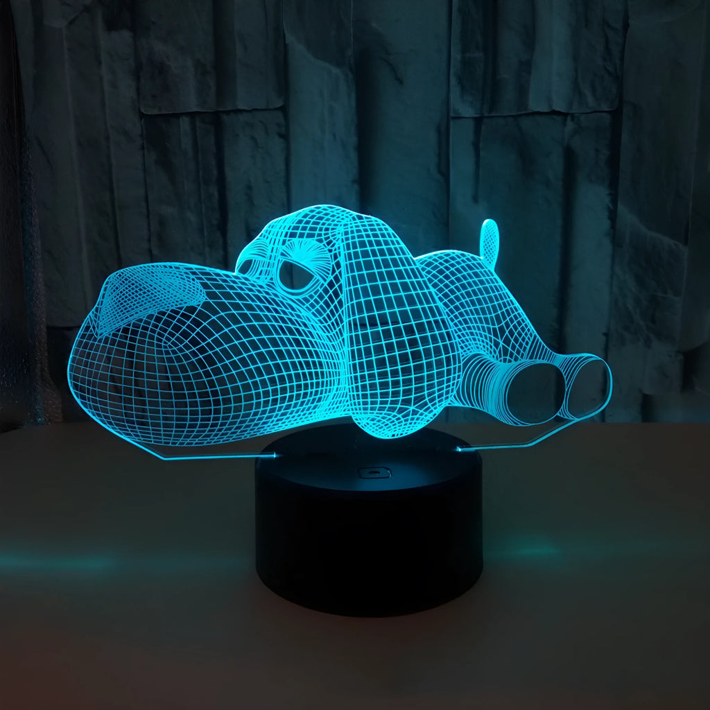 Doggo desktop lamp with 3D illusion design glowing in multiple colours on a desk.