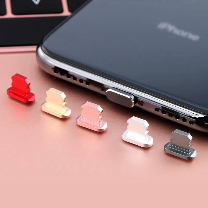 Aluminium alloy iPhone charging port dust plug shown in gold, silver, blue, red, grey, black, rose gold, and rose colours.
