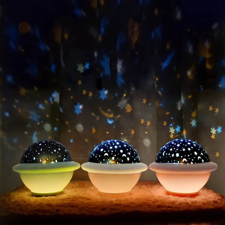 Green UFO-shaped starry sky projection light with button switch on a plastic base.