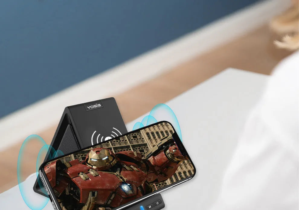 Black multifunctional mobile phone stand with built-in Bluetooth speaker and wireless charging surface